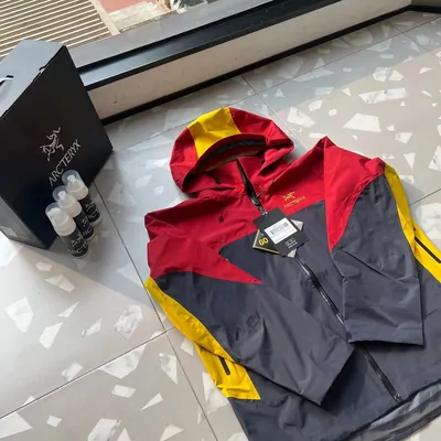 red and yellow shell jacket on a hanger