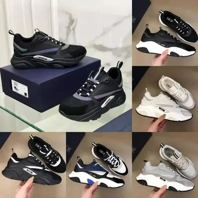chunky low-top sneakers in grey, white and black beside their boxes